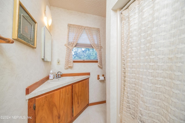 bathroom with vanity and a textured ceiling