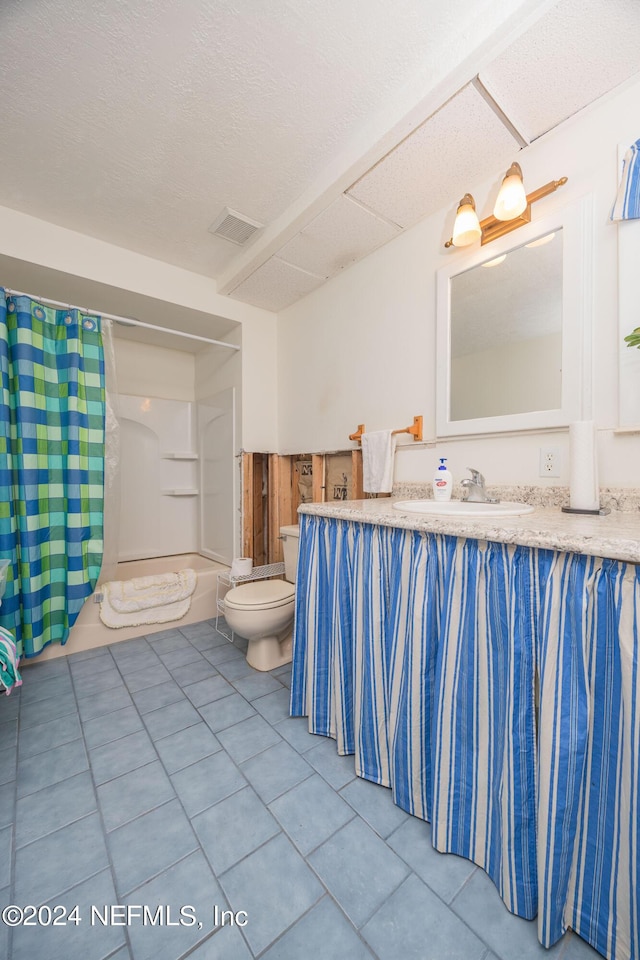 full bathroom with vanity, a textured ceiling, tile patterned floors, toilet, and shower / bath combo with shower curtain