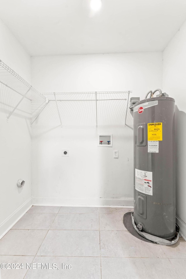 clothes washing area featuring tile patterned flooring, hookup for an electric dryer, hookup for a washing machine, and water heater