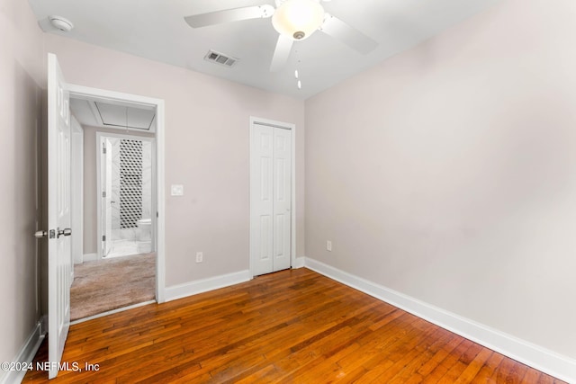 unfurnished bedroom with hardwood / wood-style flooring, ceiling fan, and a closet