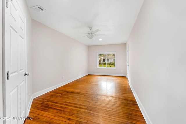 empty room with ceiling fan and wood-type flooring