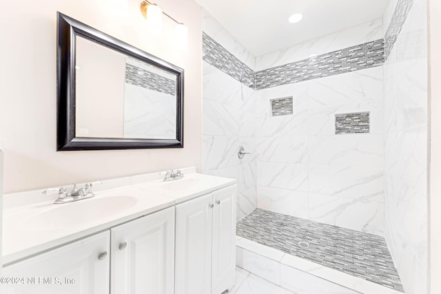 bathroom with vanity and tiled shower