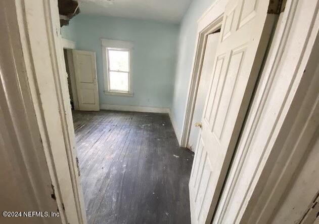 corridor with dark wood-type flooring