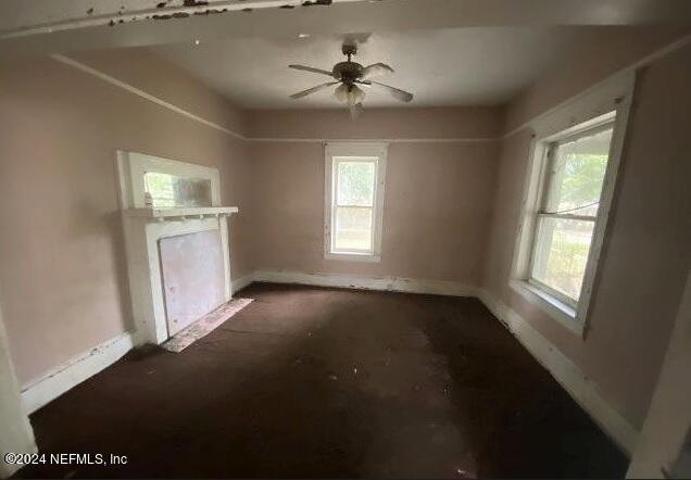 unfurnished living room featuring ceiling fan