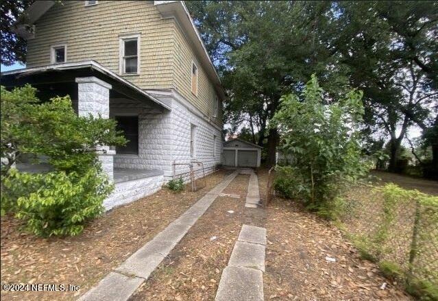 view of side of property with a garage and an outdoor structure