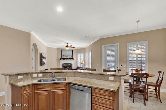 kitchen with a sink, open floor plan, hanging light fixtures, dishwasher, and brown cabinetry