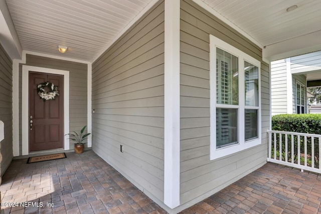 doorway to property featuring covered porch