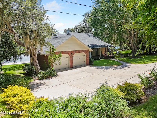 view of front facade with a garage and a front lawn