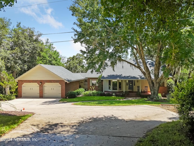 ranch-style home featuring a front yard and a garage