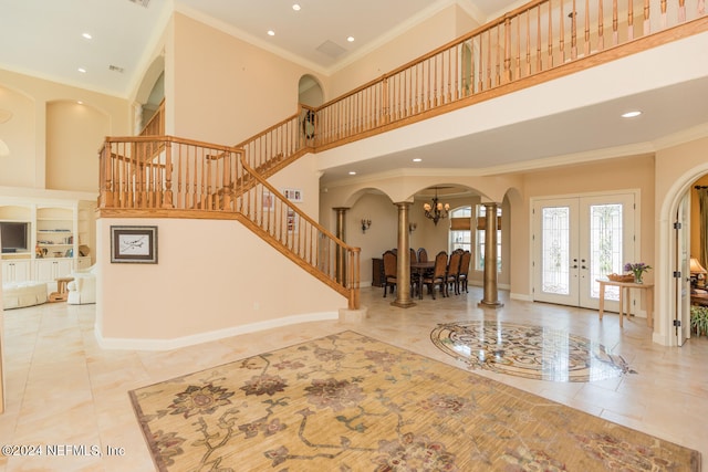 foyer featuring stairs, baseboards, and crown molding