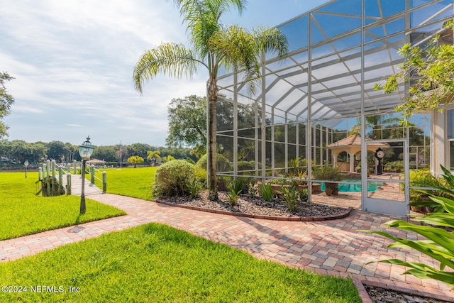 exterior space featuring glass enclosure and an outdoor pool