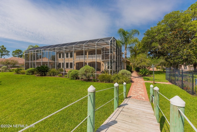 rear view of property featuring a lawn