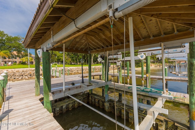 dock area with a water view and boat lift