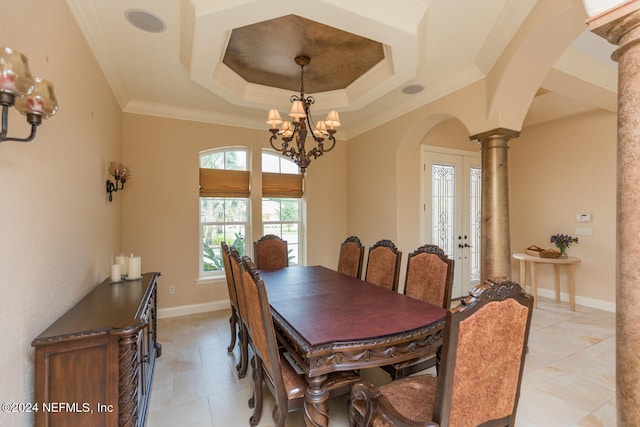 dining area with crown molding, arched walkways, decorative columns, and a tray ceiling