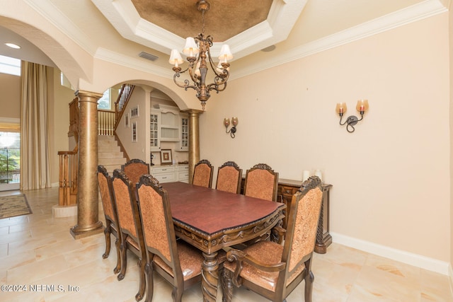 dining room featuring arched walkways, decorative columns, a raised ceiling, visible vents, and baseboards