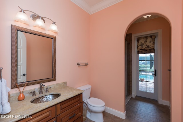 full bathroom featuring toilet, vanity, baseboards, a stall shower, and crown molding