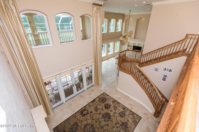 staircase featuring recessed lighting, a fireplace, and crown molding