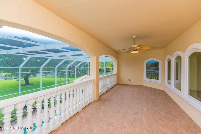 view of patio / terrace featuring a lanai and a ceiling fan