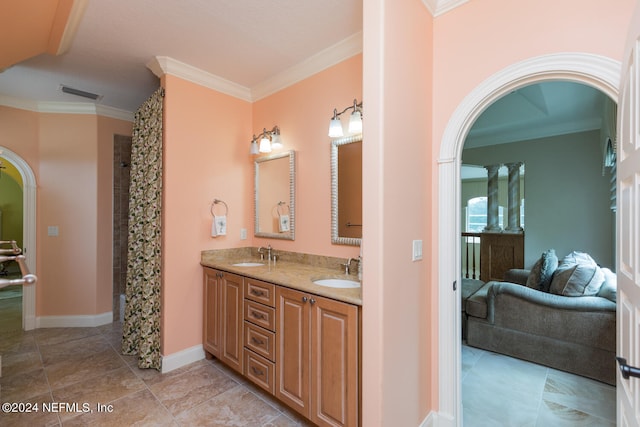 bathroom featuring crown molding, visible vents, a sink, and double vanity