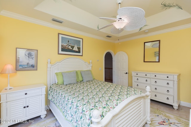 bedroom with ornamental molding, visible vents, and a ceiling fan