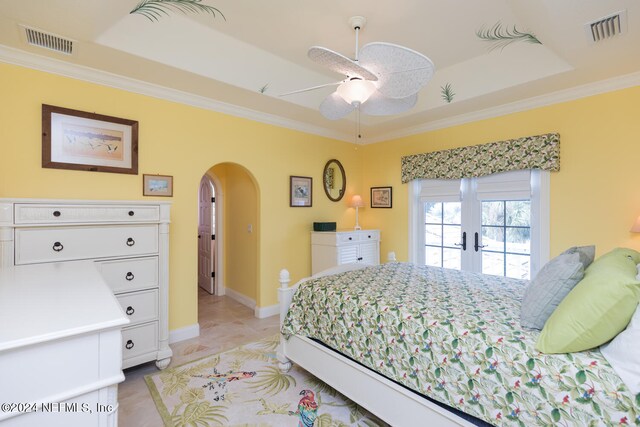 bedroom featuring visible vents, arched walkways, and crown molding