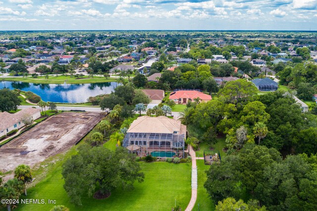 birds eye view of property with a water view and a residential view