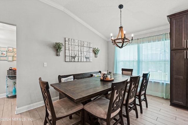 dining area featuring lofted ceiling, ornamental molding, and a chandelier