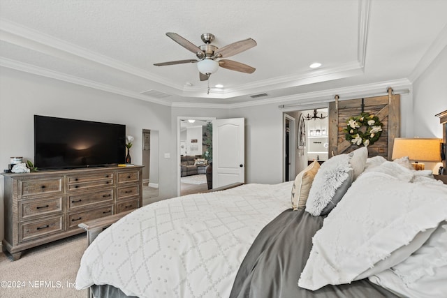 carpeted bedroom featuring crown molding, a raised ceiling, and ceiling fan