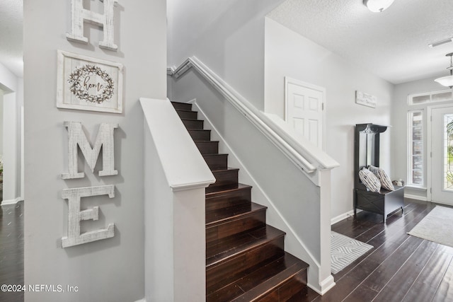 stairway with a textured ceiling