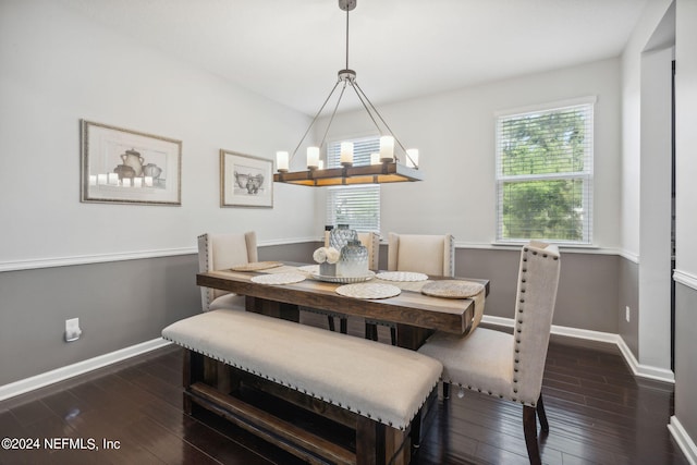 dining room featuring dark hardwood / wood-style floors and a notable chandelier