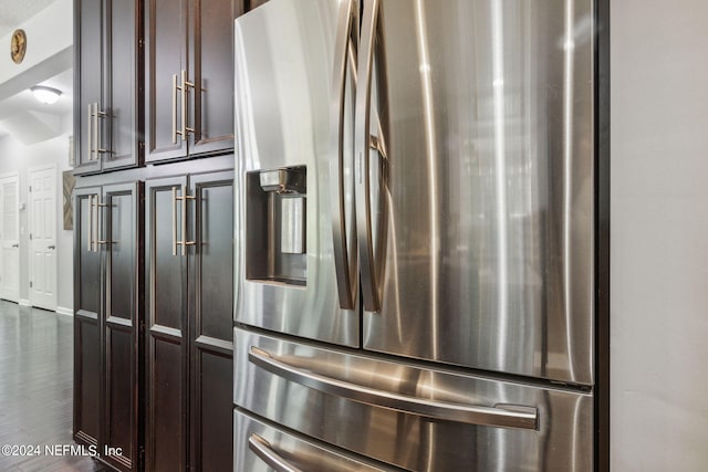 room details featuring dark brown cabinetry and stainless steel fridge with ice dispenser