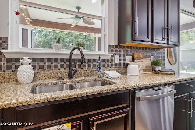 kitchen featuring dark brown cabinets, dishwasher, sink, and decorative backsplash