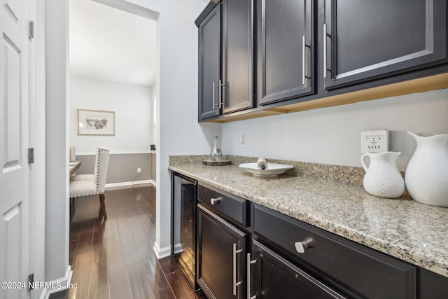 kitchen featuring light stone counters, wine cooler, and dark hardwood / wood-style flooring