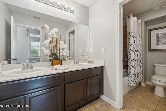 full bathroom with vanity, tile patterned flooring, toilet, and shower / bath combo with shower curtain