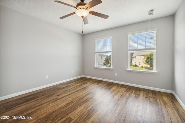 unfurnished room featuring ceiling fan, dark hardwood / wood-style flooring, and a textured ceiling