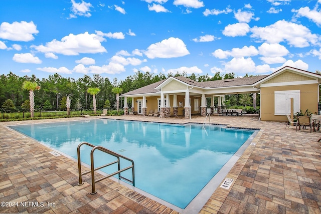 view of swimming pool with a patio