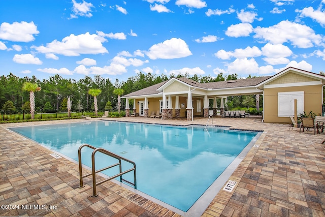 view of swimming pool with a patio area