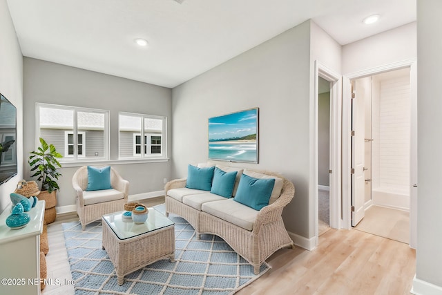 living room with recessed lighting, baseboards, and wood finished floors