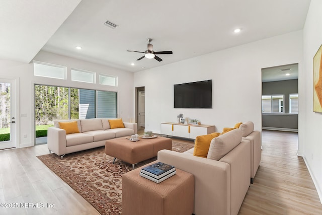 living room with light wood-type flooring, visible vents, recessed lighting, and a ceiling fan