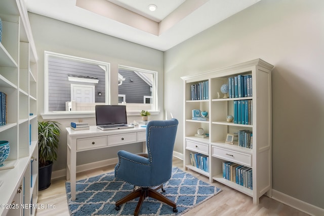 home office featuring baseboards and light wood-type flooring