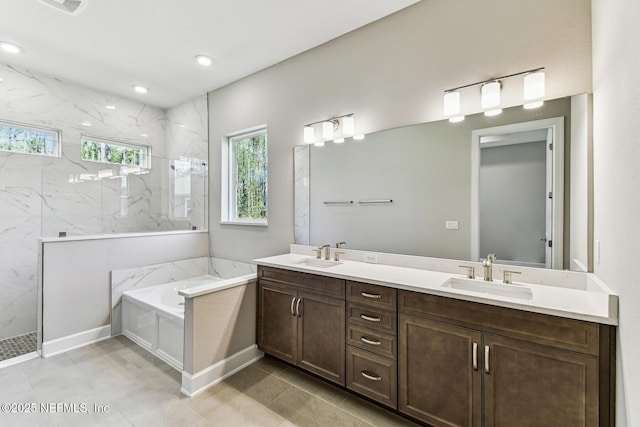 full bathroom with a garden tub, double vanity, a marble finish shower, and a sink