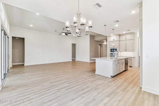 kitchen featuring built in microwave, visible vents, an inviting chandelier, and open floor plan