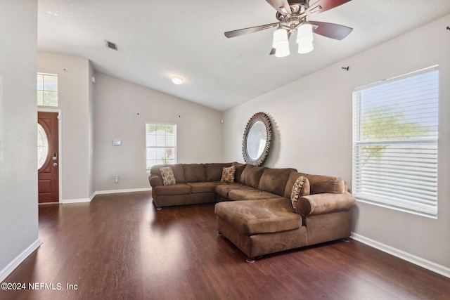 living room with dark wood-type flooring, vaulted ceiling, and ceiling fan