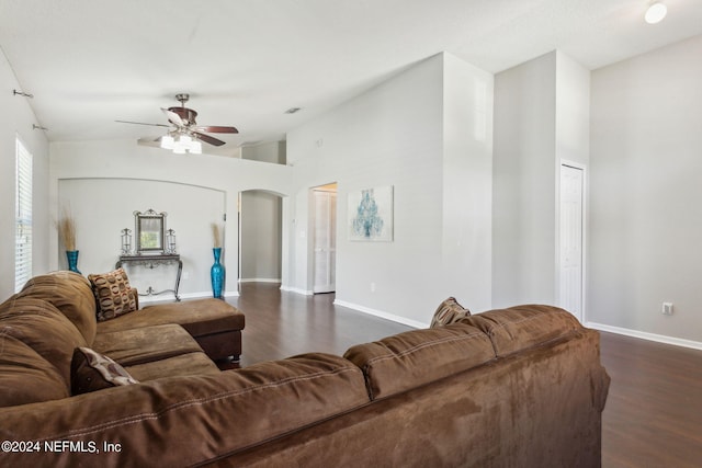 living room with ceiling fan, dark hardwood / wood-style floors, and high vaulted ceiling