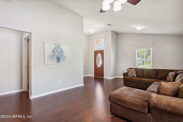 living room with dark hardwood / wood-style flooring, ceiling fan, and high vaulted ceiling