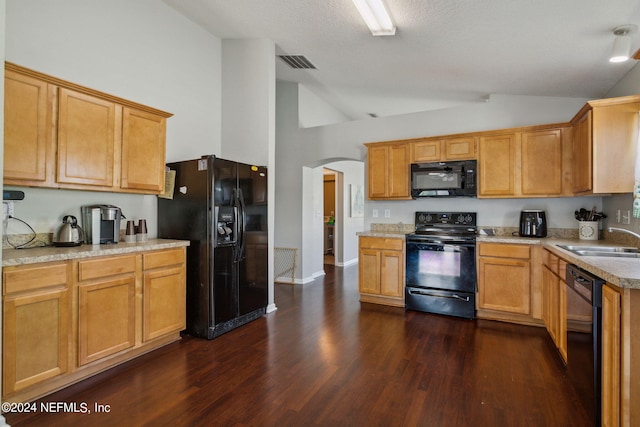 kitchen with lofted ceiling, sink, dark hardwood / wood-style flooring, and black appliances