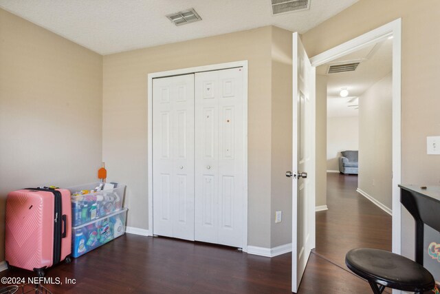 interior space with dark hardwood / wood-style flooring and a textured ceiling