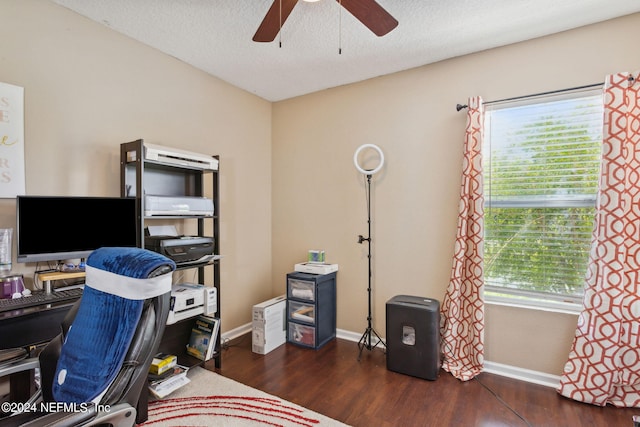 office area with ceiling fan, dark hardwood / wood-style floors, and a textured ceiling