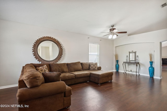 living room featuring dark wood-type flooring and ceiling fan