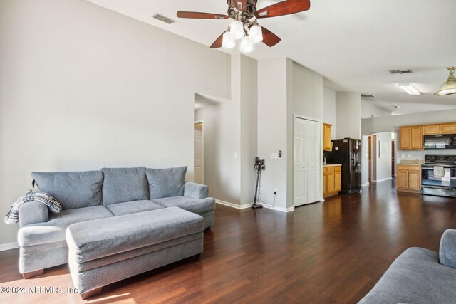 living room with ceiling fan, dark wood-type flooring, and high vaulted ceiling